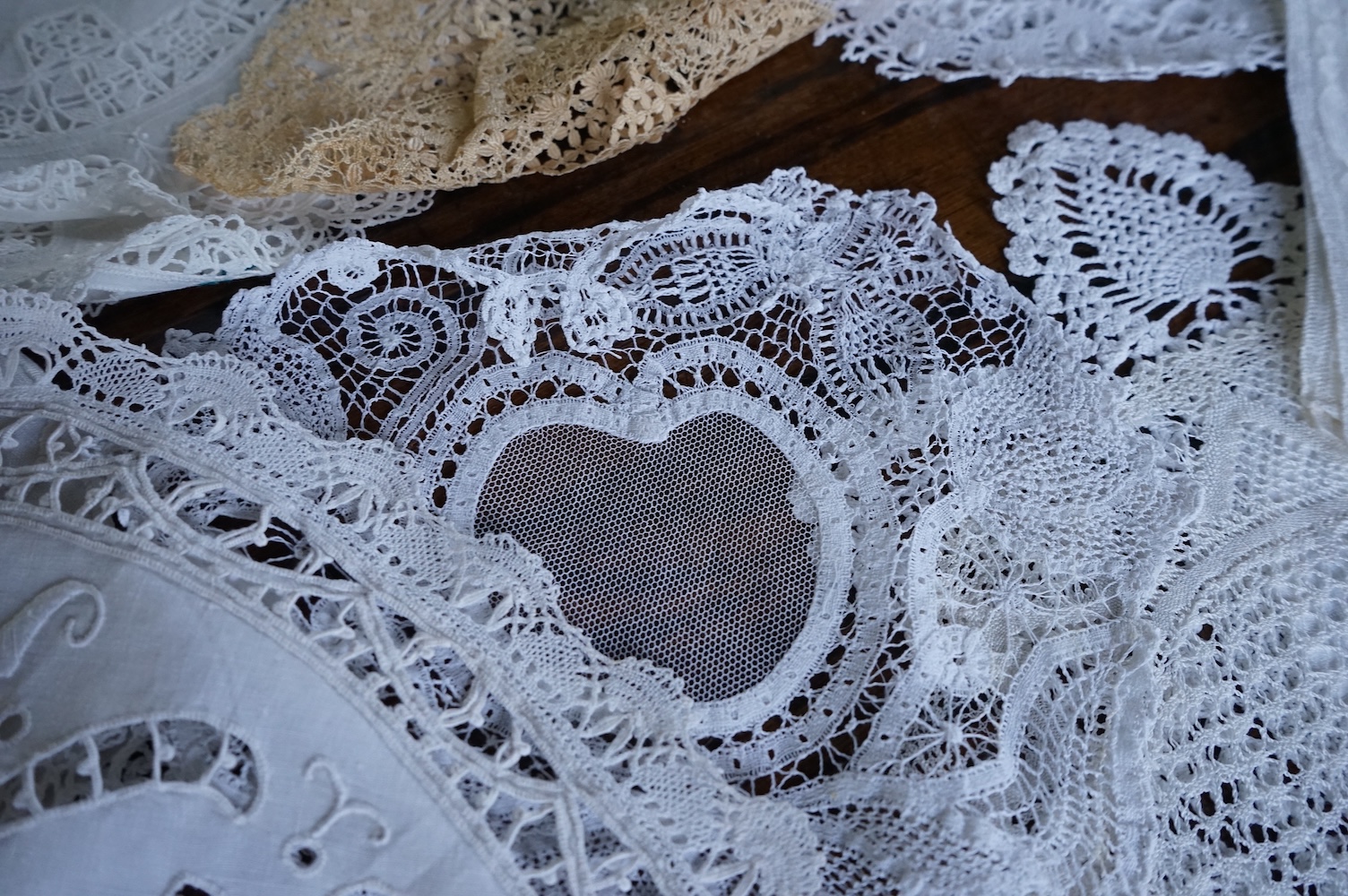 A 19th century large linen cut work collar, together with various sets of circular cut work mats, a tasselled pelmet and a collection of bobbin lace and tatting worked mats etc., Condition - mostly good